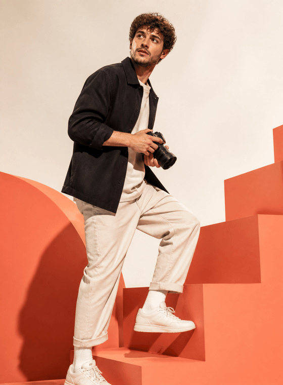 Creator holding a camera on coral steps